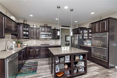 You'll love cooking in this gourmet kitchen.  Loads of cabinetry, counter space, and a large island w/storage and display shelving.