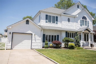 View of front of house featuring roof with shingles, a garage, and concrete driveway