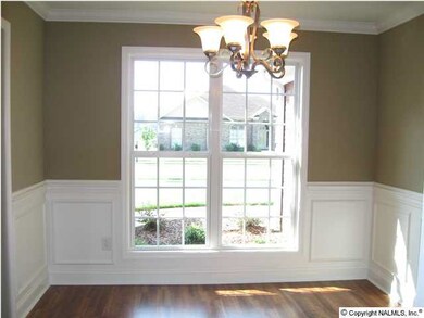 FORMAL DINING ROOM WITH EXTENSIVE TRIM WORK, LAMINATE FLOORING, & MORE!