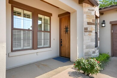 Entrance to property featuring stone siding and s