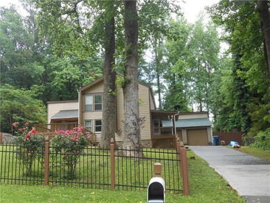 Traditional-style house featuring a garage, drivew