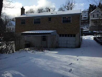 Exterior Back. Driveway and one car garage.