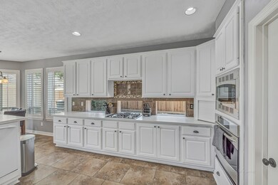 SPACIOUS KITCHEN - with TONS of countertop space, built-in stainless steel appliances, raised dishwasher and a BIG pantry.