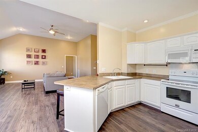 Kitchen has an electric oven and overhead microwav