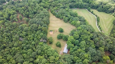 Beautiful land with gorgeous tress and a 40' x 60' steel building