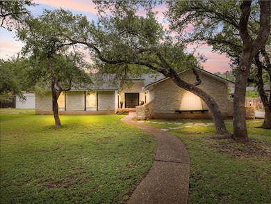 Mid-century modern home with stone siding and a l