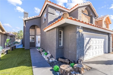 Mediterranean / spanish home with a tiled roof, stucco siding, a chimney, and a front lawn