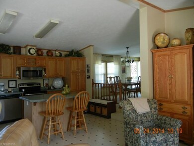 Entered through front door, view of kitchen, dining room and front entrance from family room