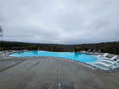 Community pool with fence and a patio area