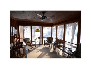 Porch. Enclosed porch overlooks woodlands, gardens