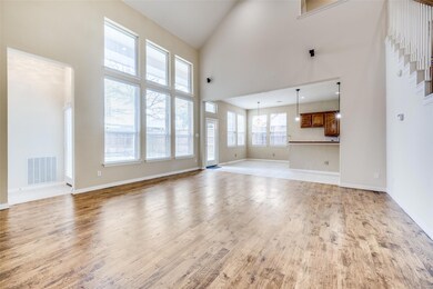 Living room features durable, hand-scraped solid w