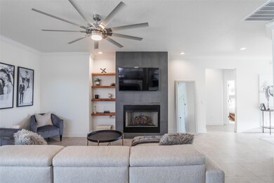 Living room with gas fireplace and custom wood shelving