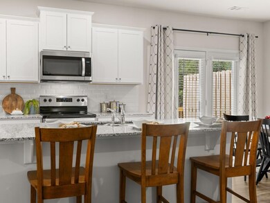 sudbury townhome kitchen with white cabinets and g