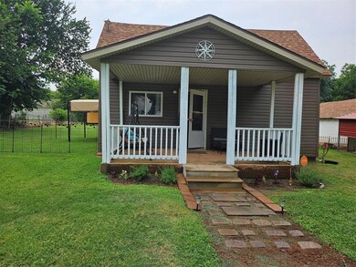 Bungalow with a front lawn and a porch
