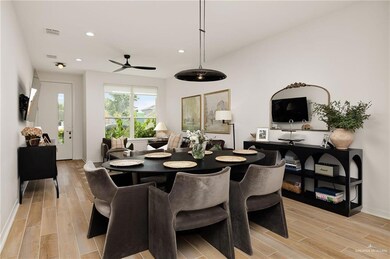 Dining space featuring light wood finished floors, ceiling fan, and recessed lighting