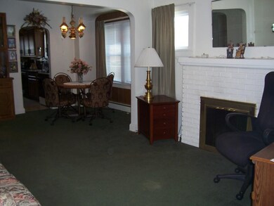 Living room w/fireplace, leading into the dining r