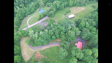 Aerial view of the long winding drive way, and home. 