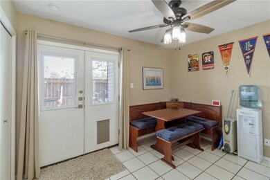 Dining space featuring ceiling fan and light tile