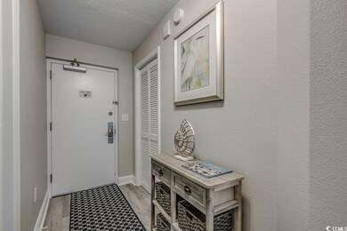 Doorway with hardwood / wood-style flooring and a 