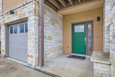 Doorway to property with stone siding and stucco siding