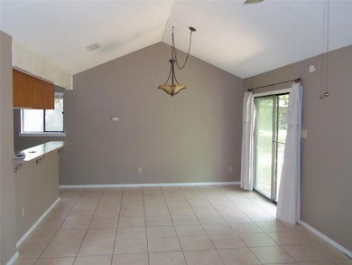 Unfurnished dining area featuring vaulted ceiling