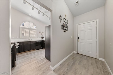 Entry way with kitchen to the right.