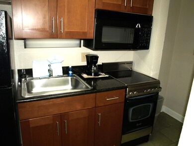 Kitchen with tile patterned floors, sink, and blac
