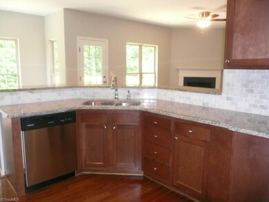 Kitchen with stainless appliances, granite counters, marble subway tile backsplash, nice wood cabinets