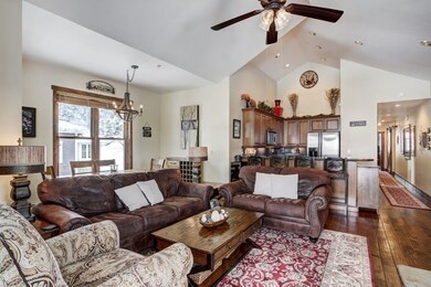 Living area with high vaulted ceiling, ceiling fan