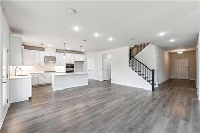 Kitchen with tasteful backsplash, a center island,