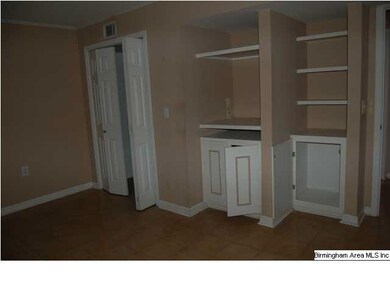 den/media room downstairs with built in bookshelves and closet.