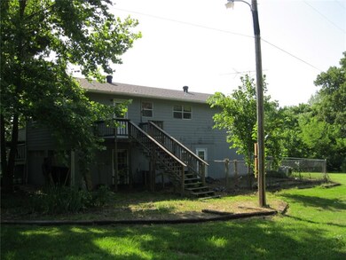Rear of home with fenced dog yard, or garden area.