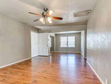 Empty room featuring a ceiling fan, wood finished 