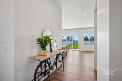 Hallway with dark wood finished floors and recessed lighting