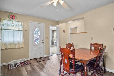 Hardwood floored dining space featuring ceiling fa