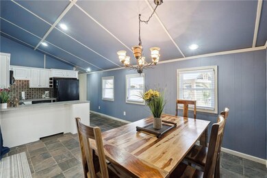 Dining area featuring baseboards, stone finish flo