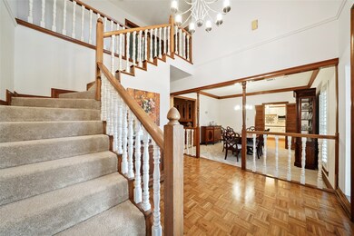 The home has new carpet throughout. This view shows 1 of 2 staircases to the second floor. To the right is the dining room, located just off the kitchen.