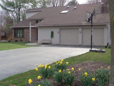 Lovely home features many garden beds.