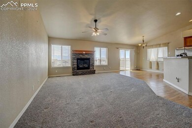 Unfurnished living room featuring ceiling fan with