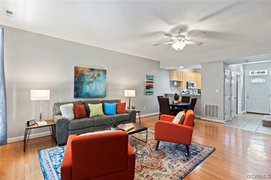 Living room with ceiling fan and light hardwood fl