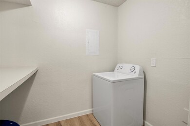 Laundry area with hardwood / wood-style floors, wa