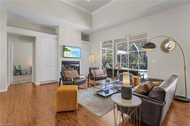 Living area with a sunroom, light wood-style floor