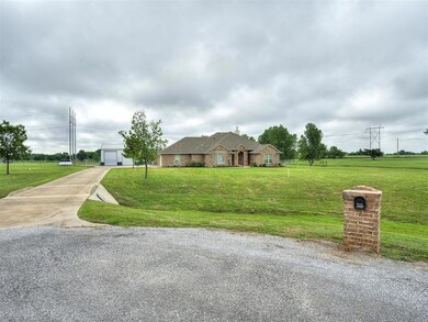 View of front of home with a garage and a front ya