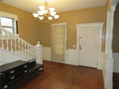 Foyer, staircase and front door.  Desk with bench seat stay with the home.