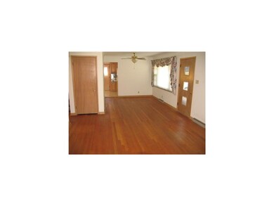 Living Room. Owners have pulled up the old carpet 