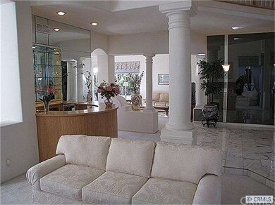 Living room looking through to the wet bar and fam