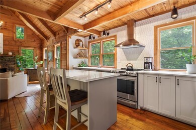 Kitchen with track lighting, light hardwood / wood