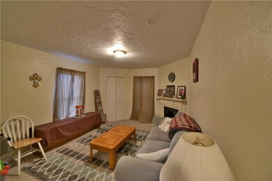 Upper unit Living room with decorative fireplace
