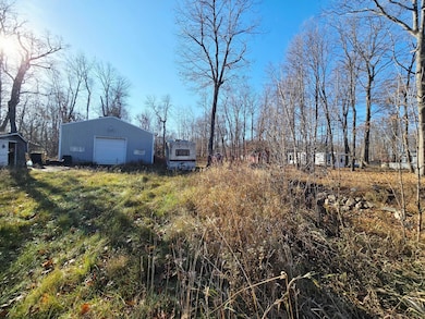 Pole building with concrete flooring and power. Camper can stay with the property