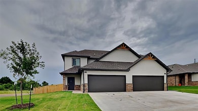 Craftsman house with a shingled roof, driveway, and an attached garage